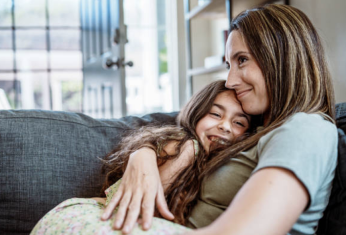 holiday tress mom hugging daughter on a couch